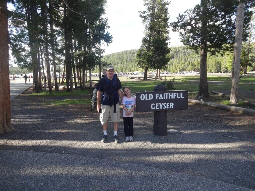 Father and daughter with sign