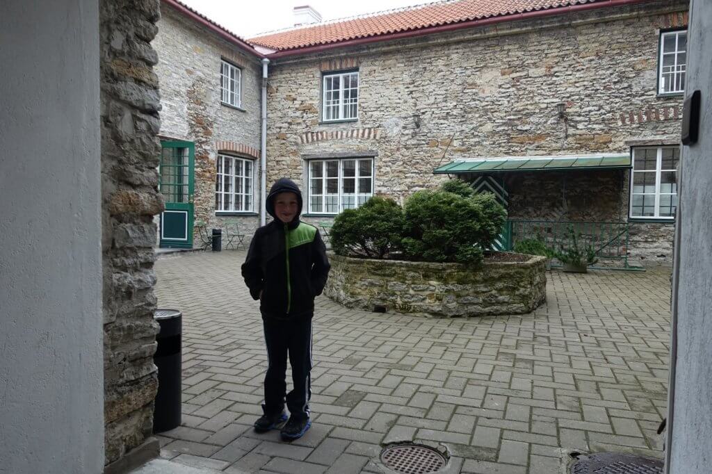 boy standing in courtyard