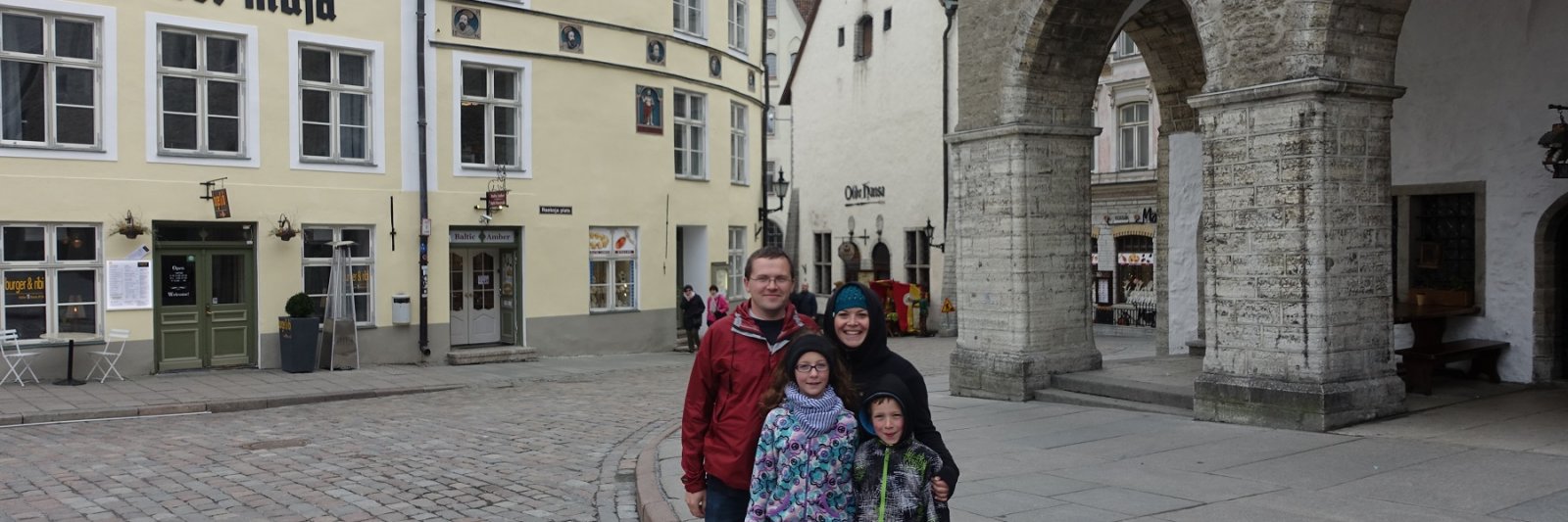 family in front of old buildings