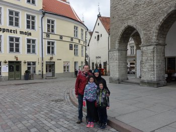 family in front of old buildings