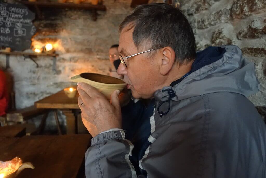 man drinking soup from a bowl