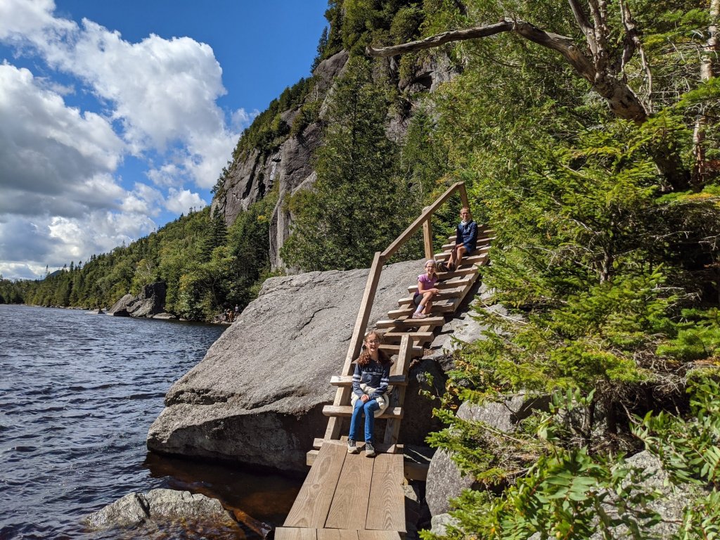 kids sitting on step ladder in mountains