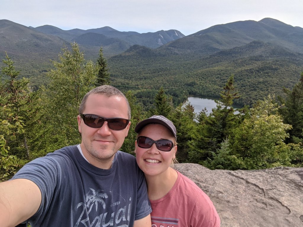 man and woman on top of mountain