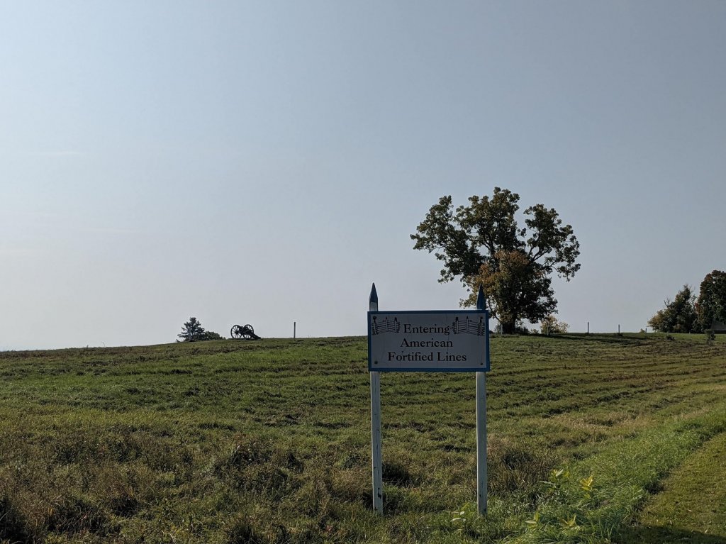 sign with tree and cannon