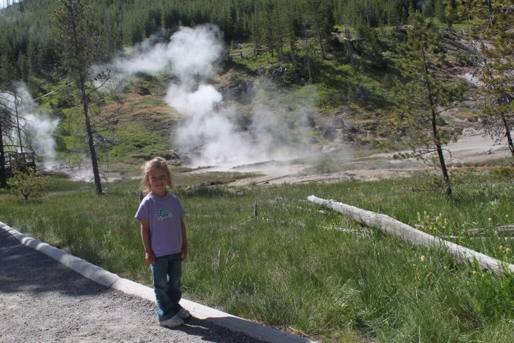 Girl in front of steam vents