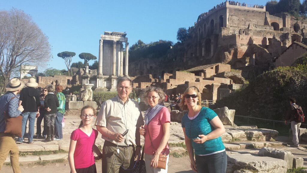 people in front of ancient ruins