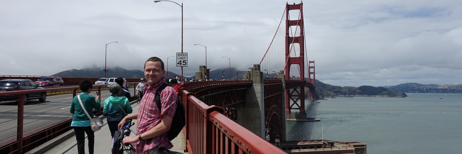 man on bridge with bike