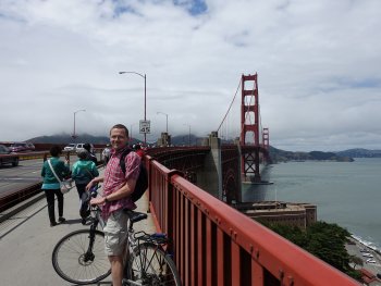 man on bridge with bike