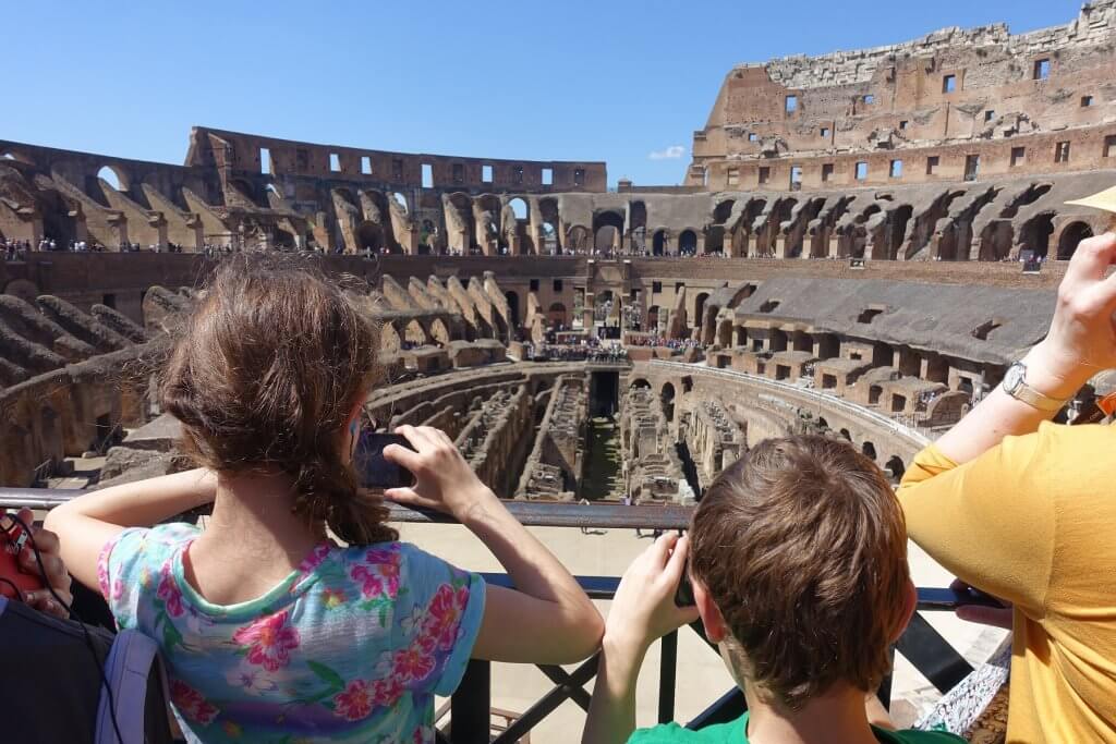 kids taking pictures inside Colosseum