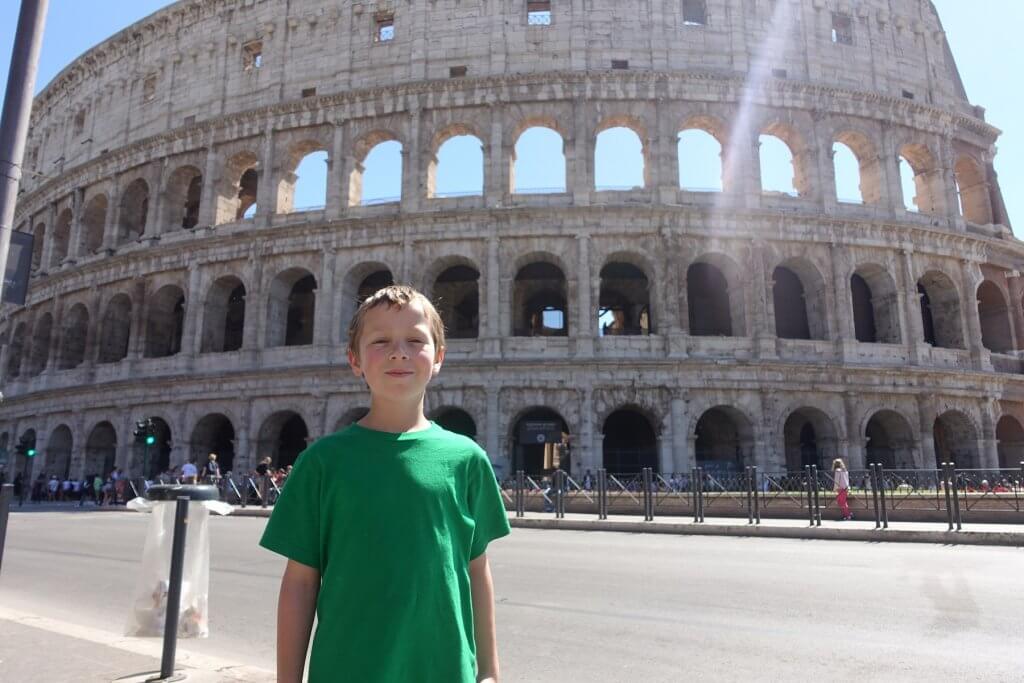 boy in front of the Colosseum