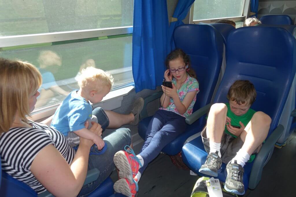 kids on phones on a train