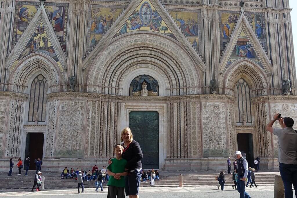 woman and boy in front of church