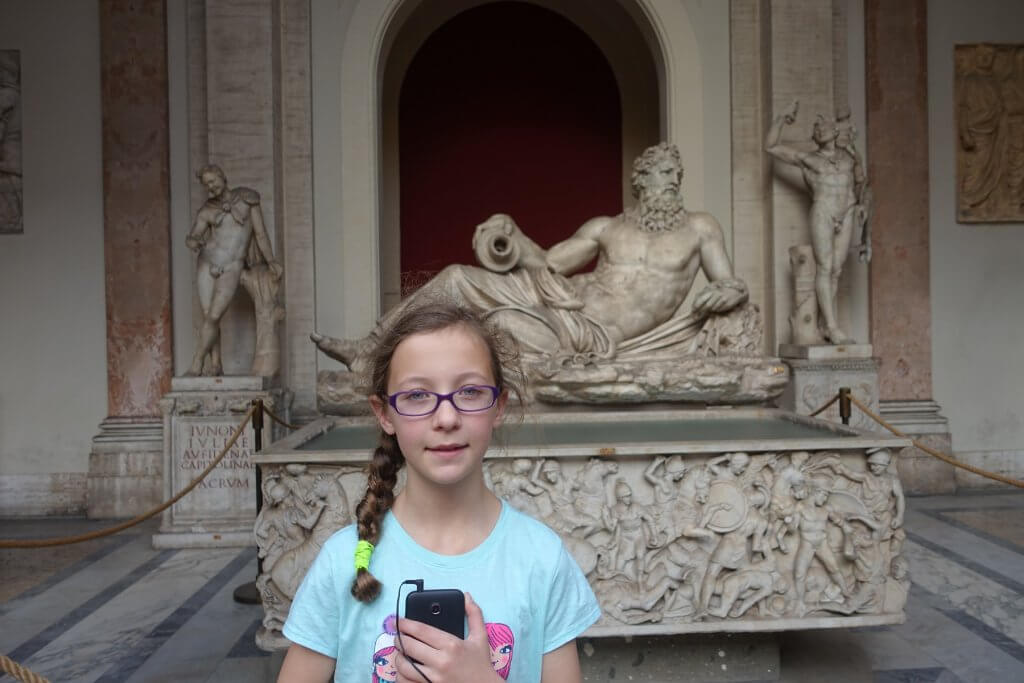girl in front of statue
