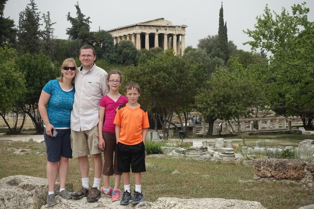 family in front of columned building