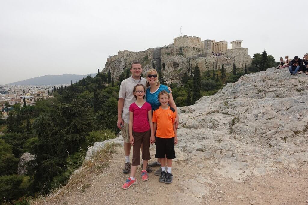 family in front of ancient structures