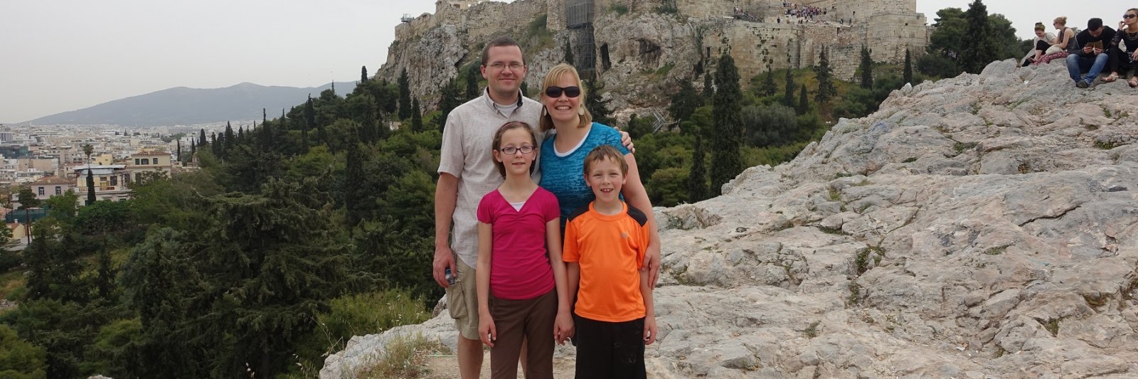 family in front of ancient structures