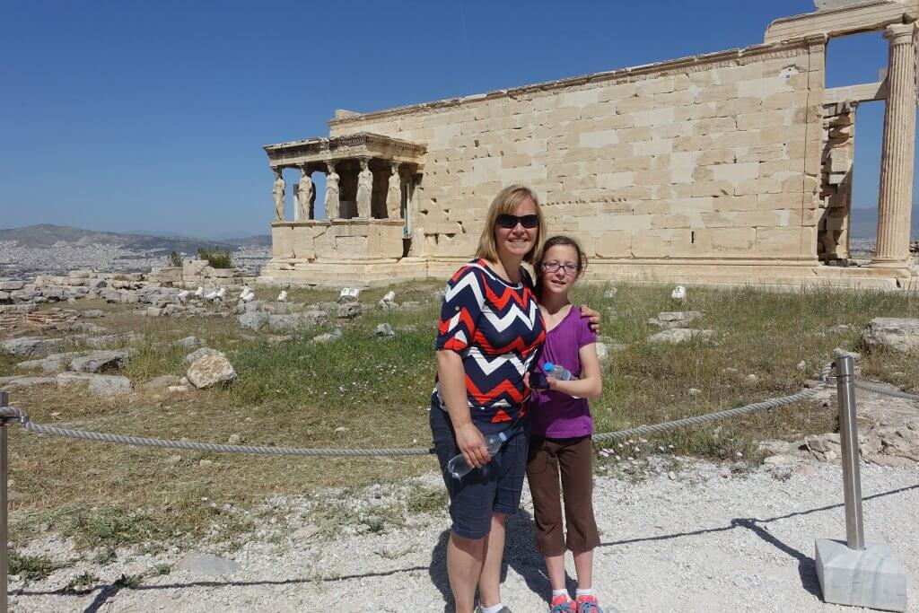 woman and girl in front of ancient building