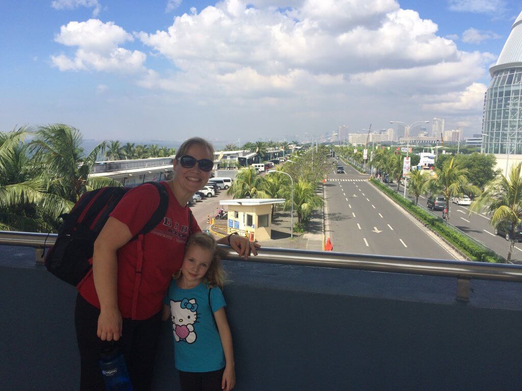 woman and girl on overpass over road