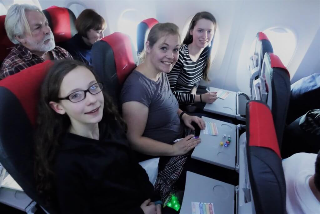 people playing dice game on airplane