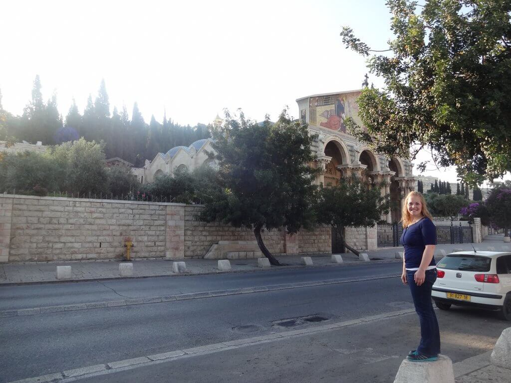 woman in front of ancient church