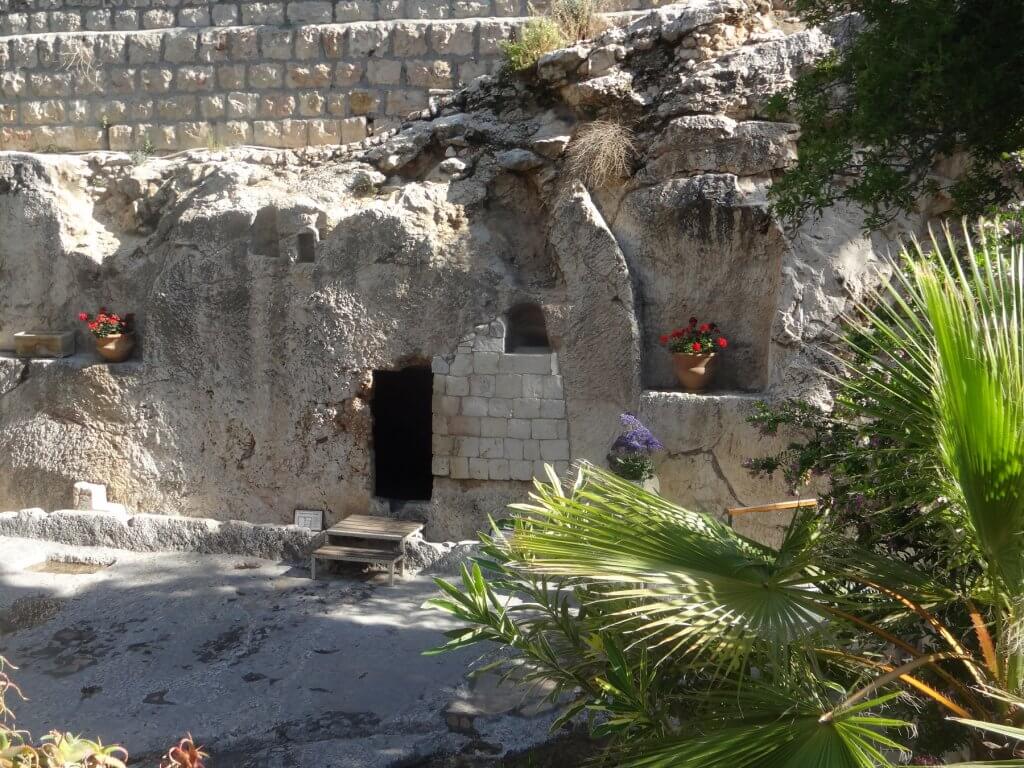 tomb in rock with flowers