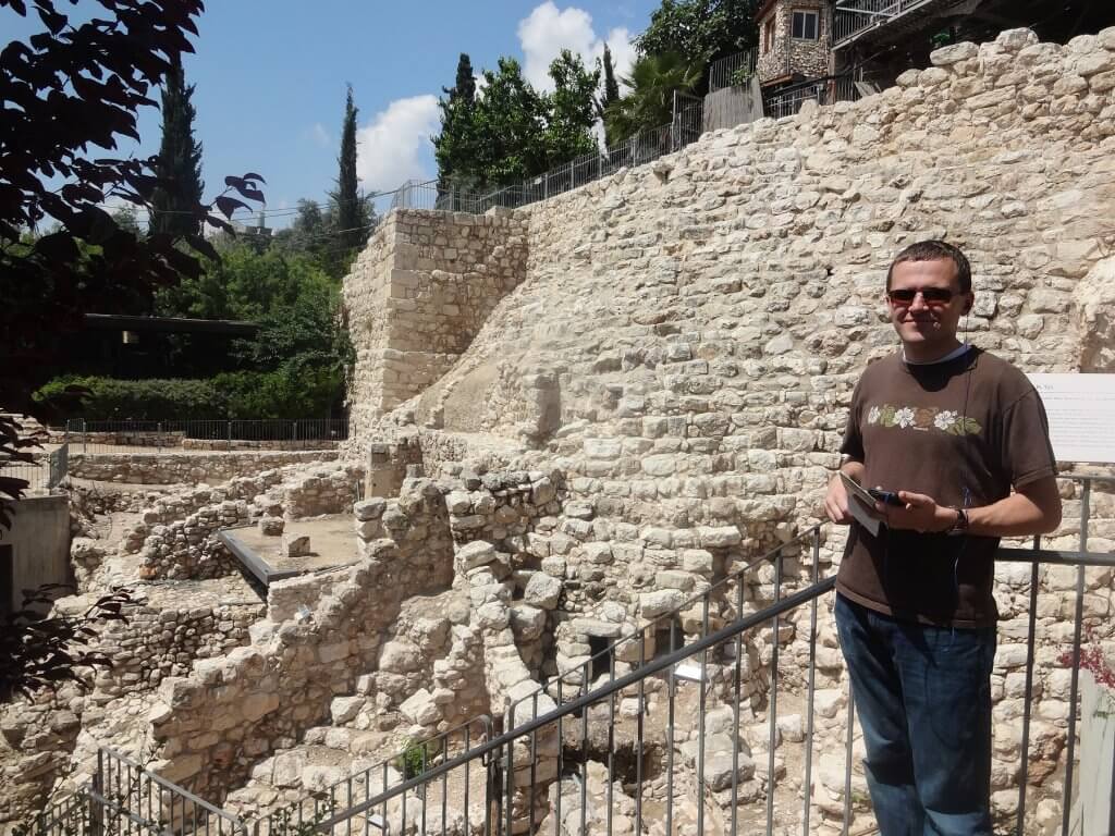 man in front of ancient stone structures