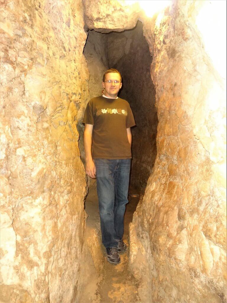 man in a rock tunnel