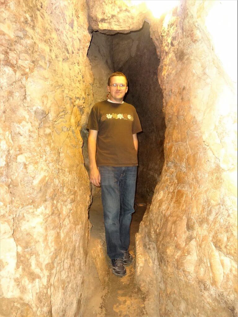 man in a rock tunnel