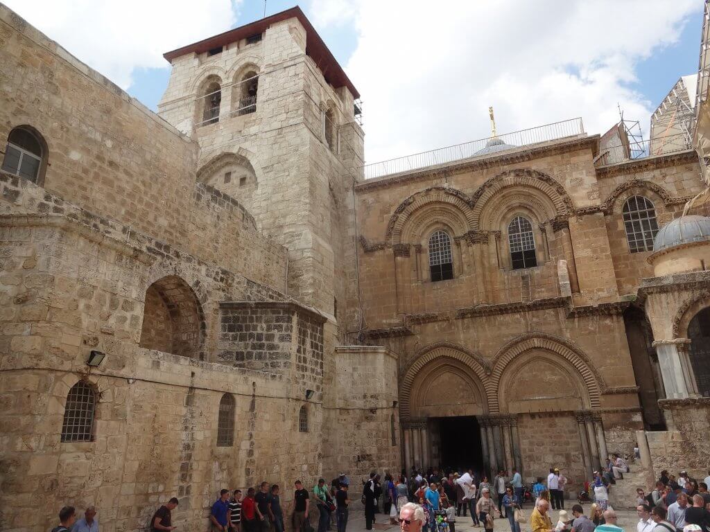 ancient building with people milling around