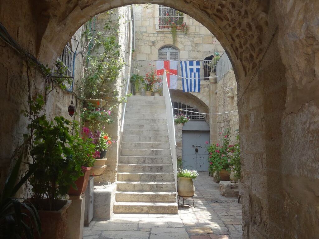 archway with staircase and plants