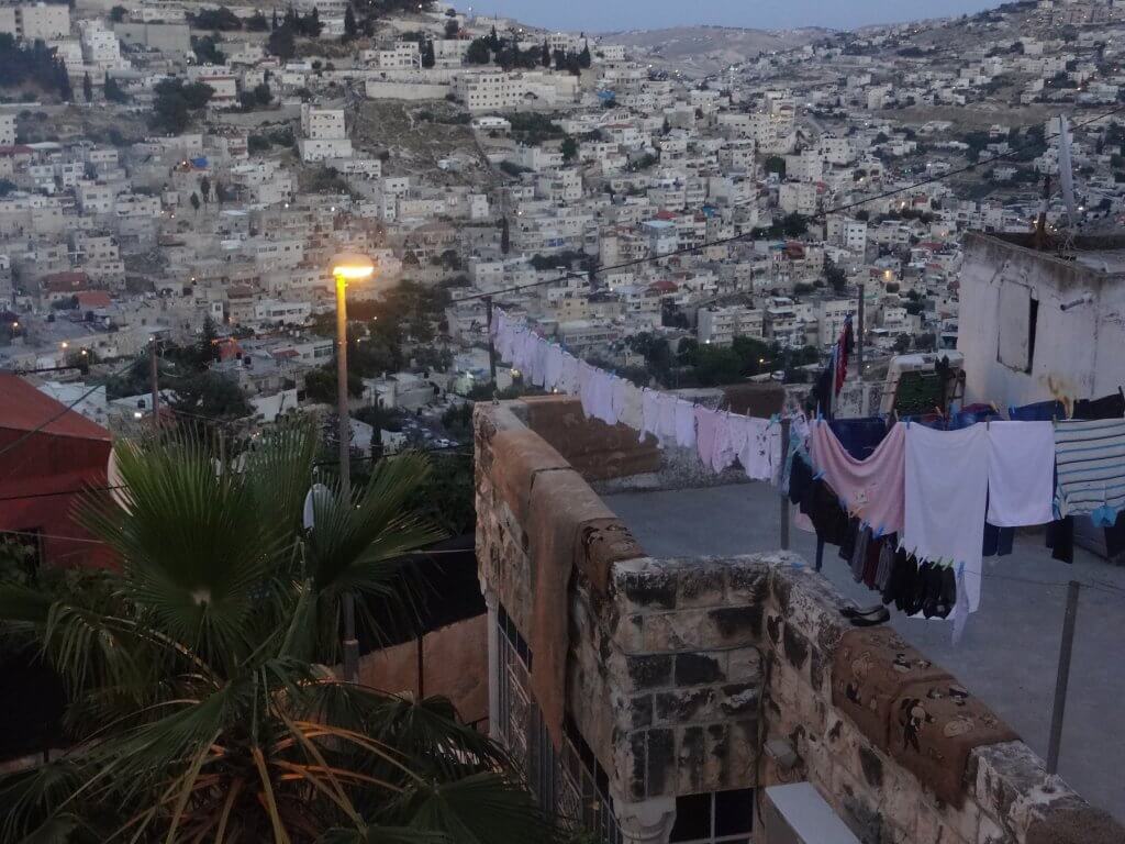 buildings on a hillside and clothesline on roof