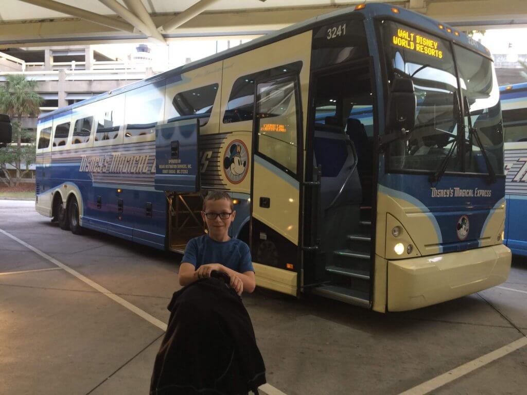 boy in front of bus