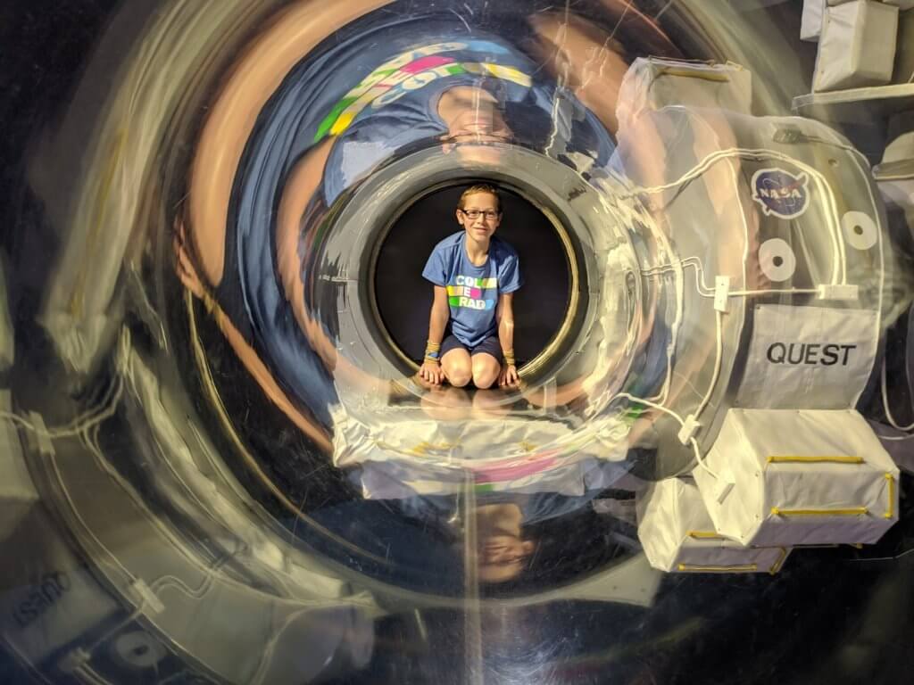 boy in a clear tube