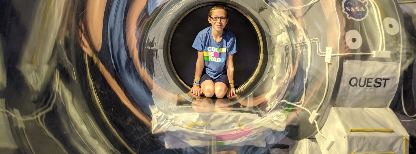 boy in a clear tube