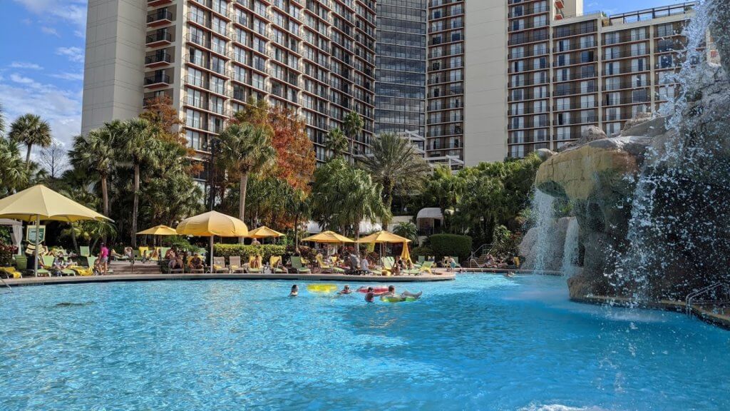 pool with waterfall and hotel in background