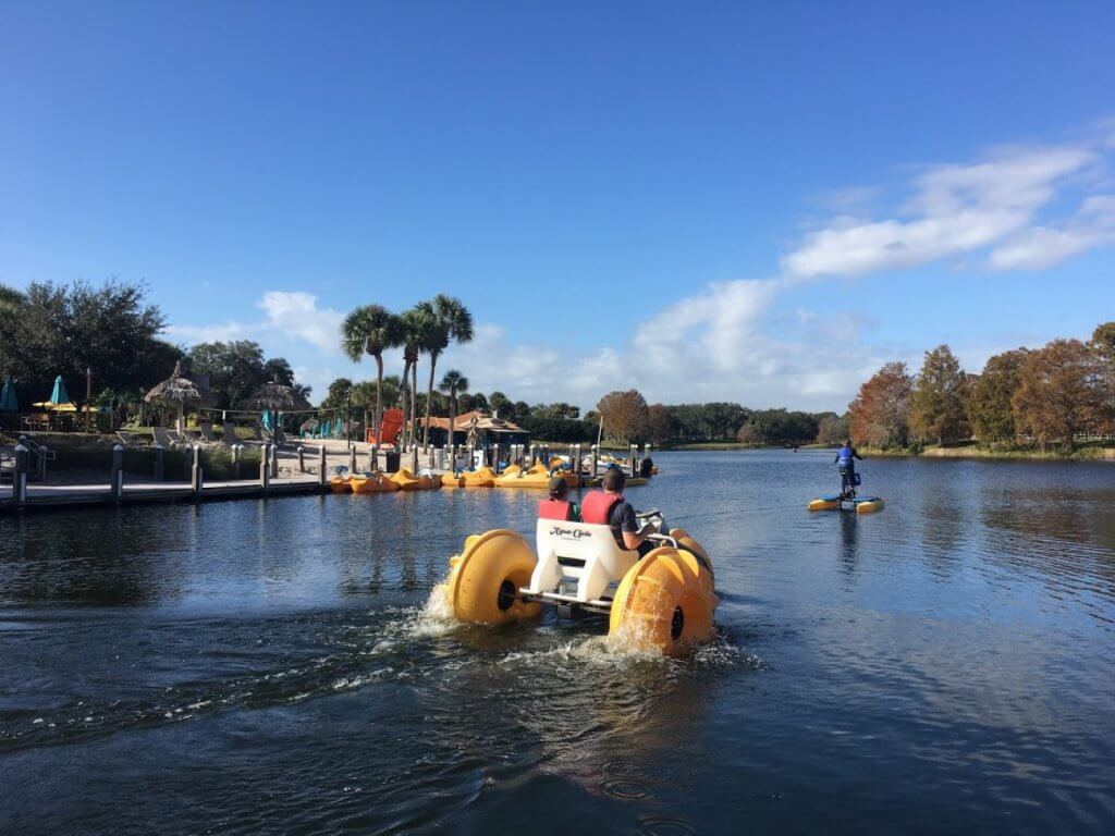 father and son on pedal boat and girl on hydro bike