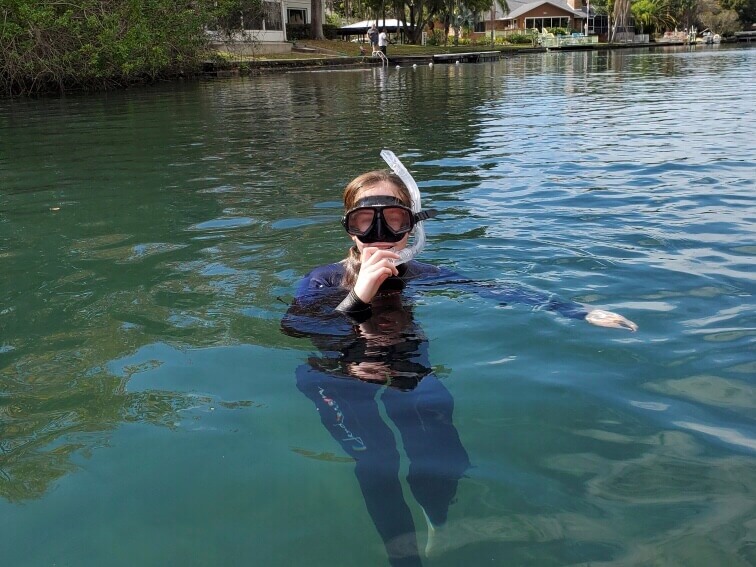 girl swimming with snorkel maks