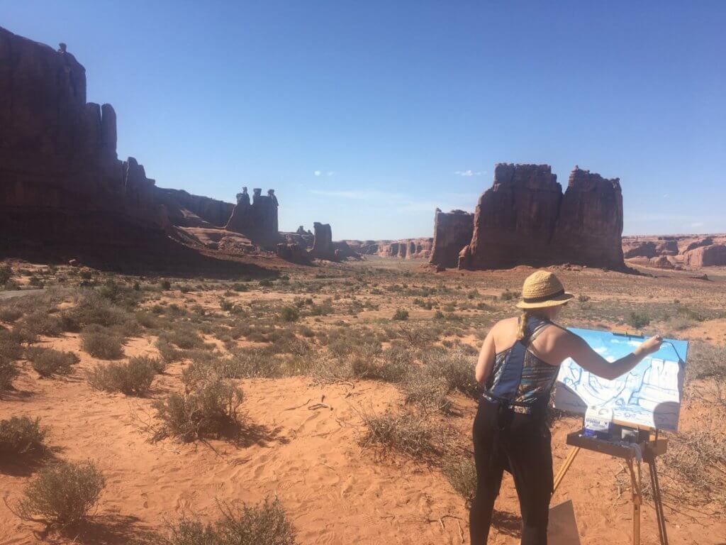 woman painting rock monuments