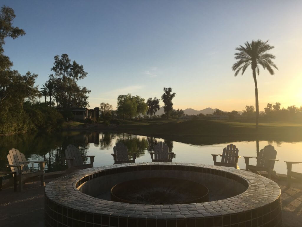 circle fire pit in front of lake