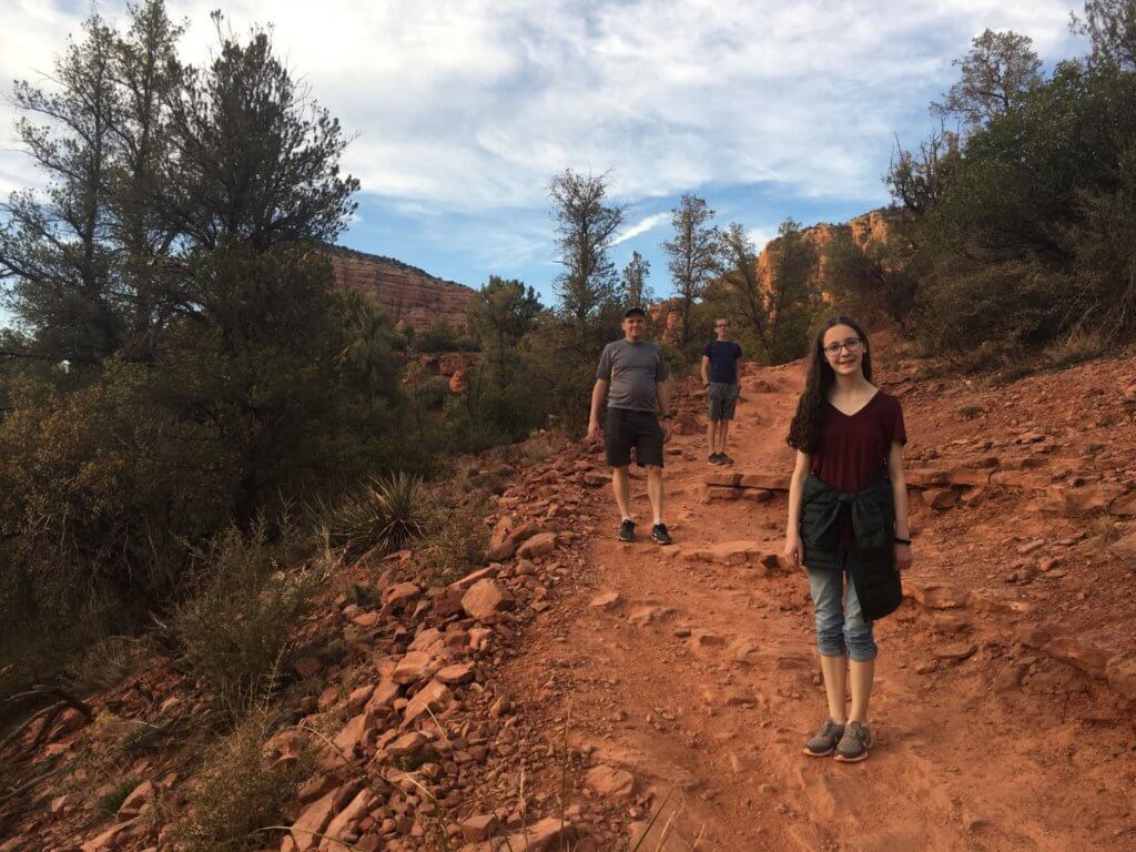 family on red hiking path