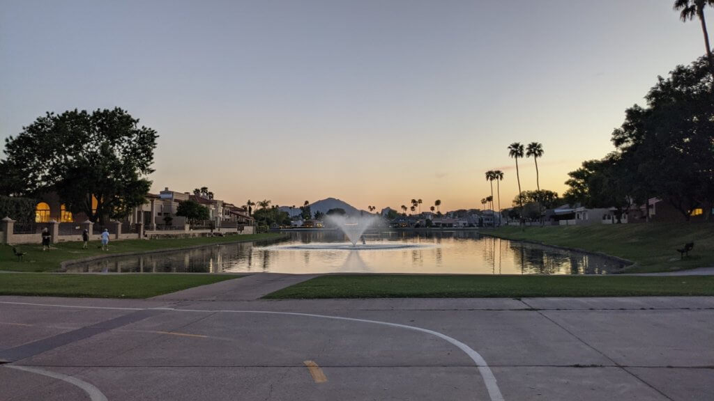 water fountain in pond with bike path