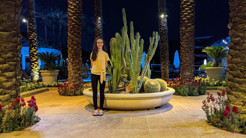 girl standing by cacti