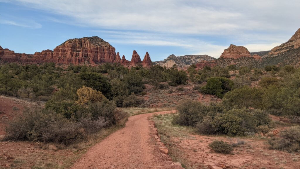 red sand trail and red rock mountains