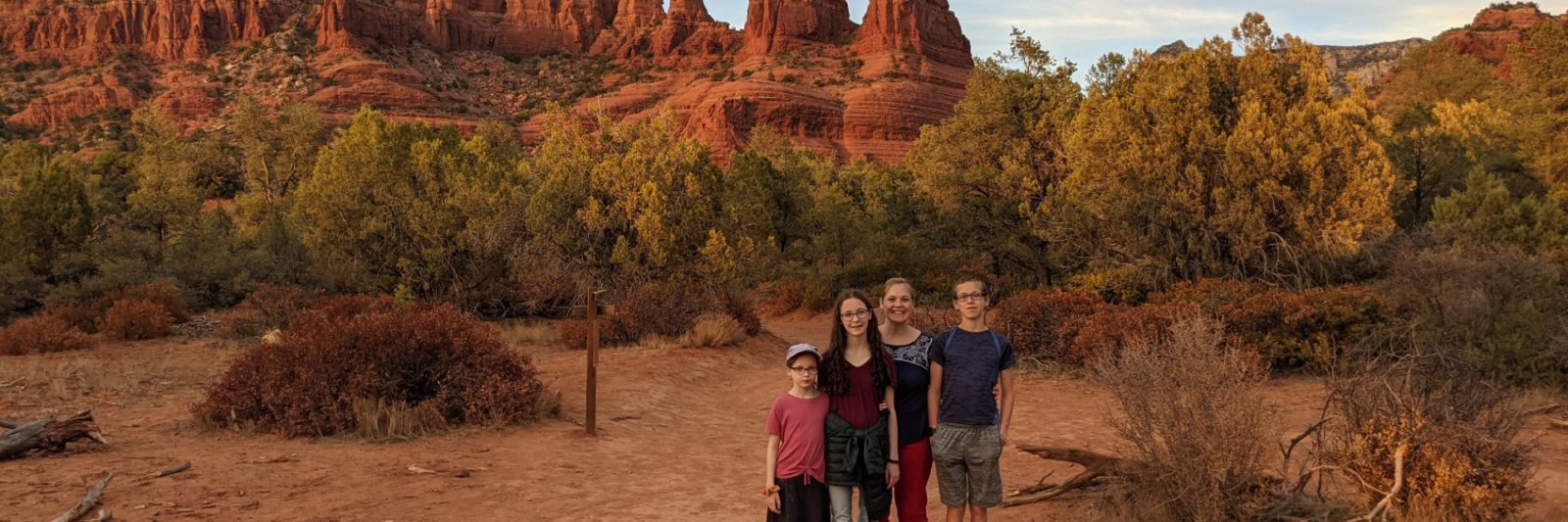 family in front of red mountains