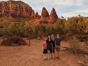 family in front of red mountains