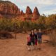 family in front of red mountains