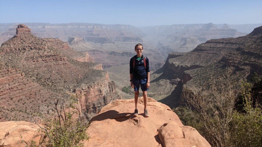 boy standing on a rock