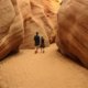 girl and boy walking in narrow canyon