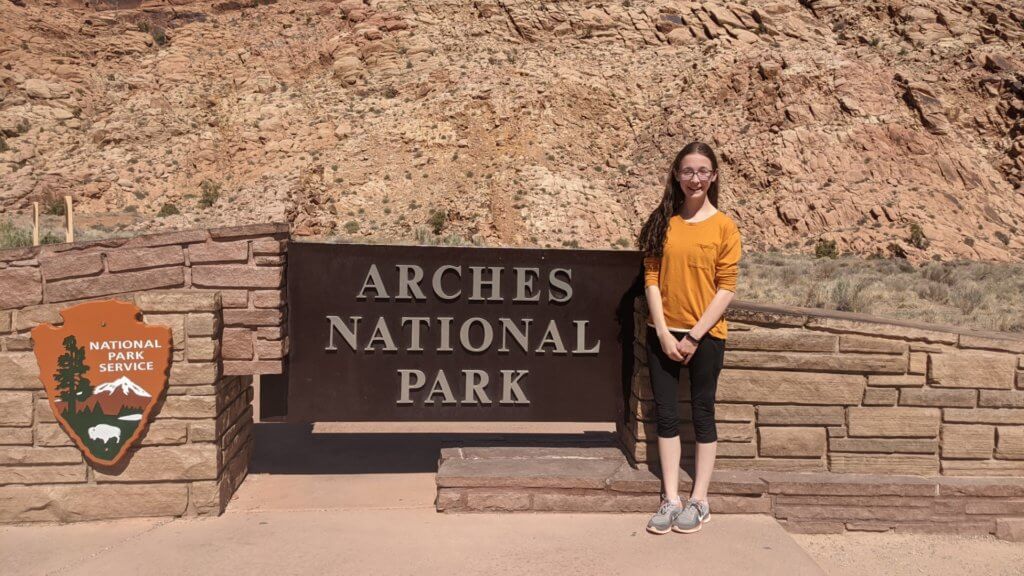 girl in front of National Park sign