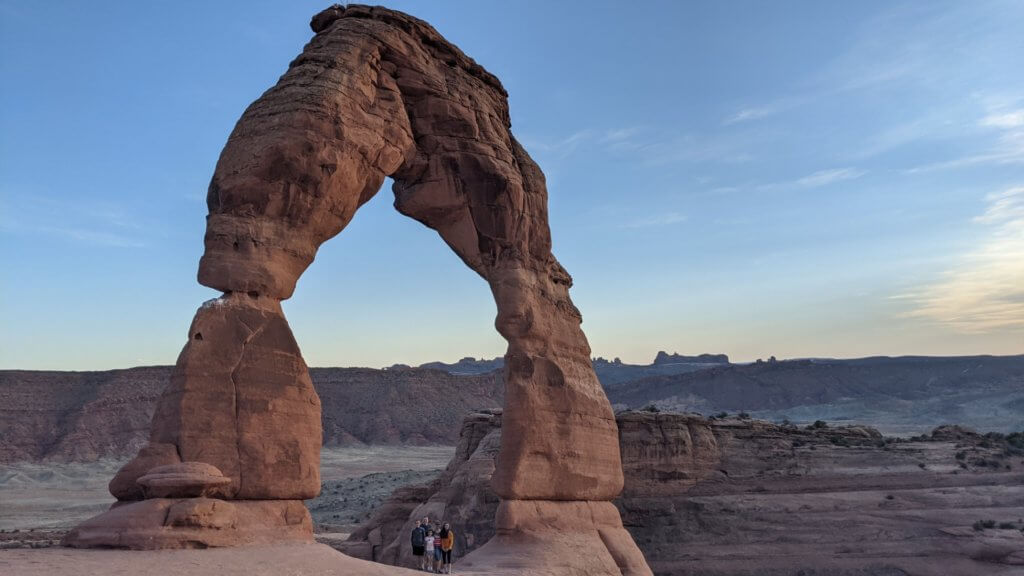 family under natural arch